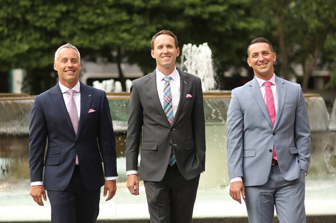 Physician Financial advisors wearing business suits in front of a fountain